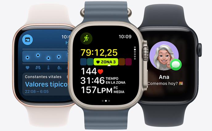 Tres modelos de Apple Watch: el del centro, en color natural, muestra el entreno Correr iniciado con datos de frecuencia cardiaca; el de la derecha, en negro azabache, muestra un Genmoji, y el de la izquierda, en oro rosa, muestra la app Constantes Vitales