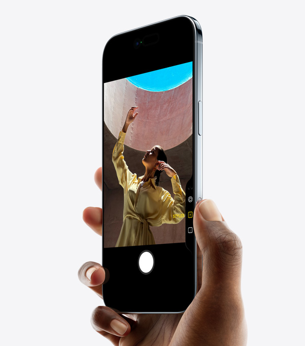 A hand holding iPhone Air with thumb on Camera Control button, front exterior, side exterior, thin profile, Dynamic Island, side button